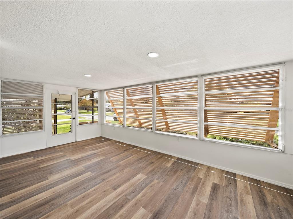 1610 Reynolds Road, Unit 35 Lakeland, FL 33801 - Photo 4 of 59 a view of an empty room with a window and wooden floor
