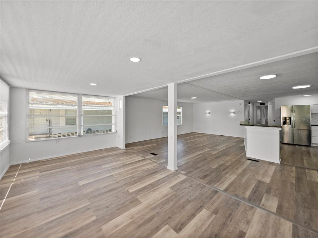1610 Reynolds Road, Unit 35 Lakeland, FL 33801 - Photo 6 of 59 a view of a kitchen with wooden floor and a window
