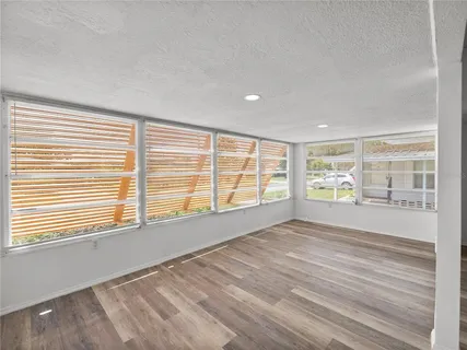 a view of kitchen living room with wooden floor and electronic appliances