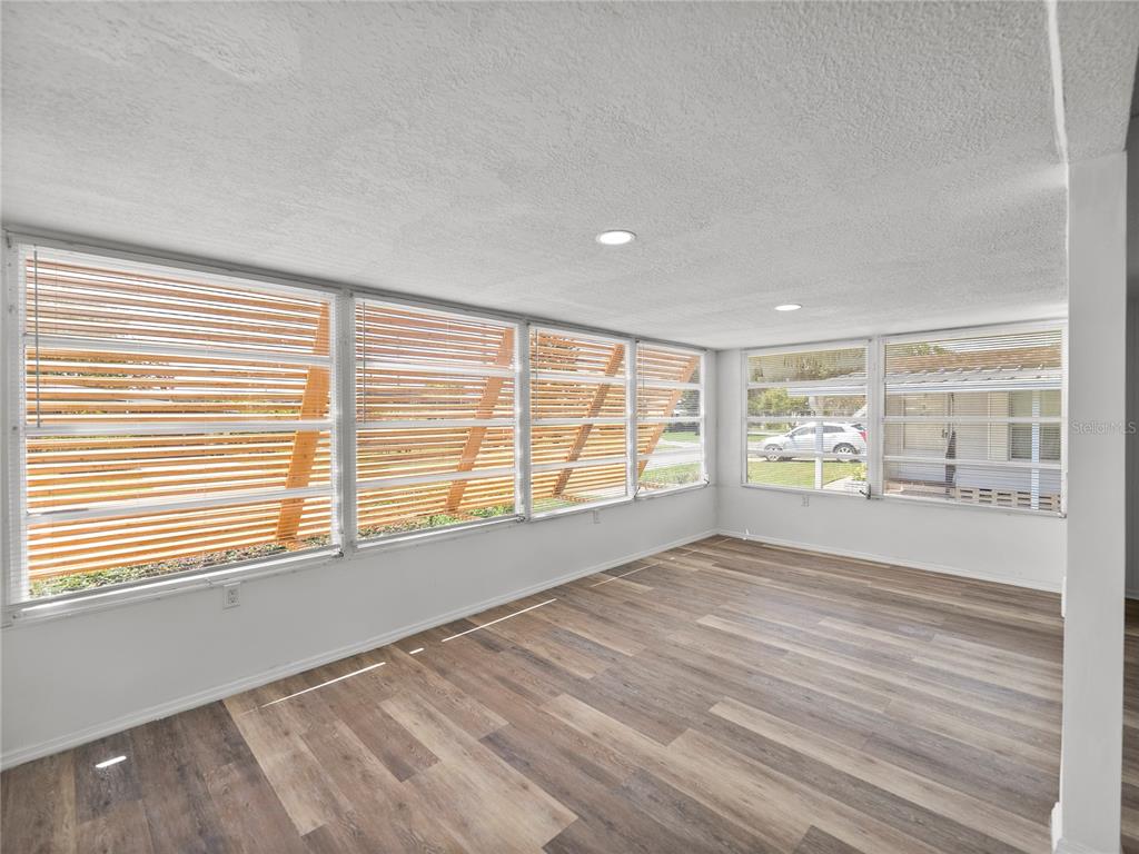 1610 Reynolds Road, Unit 35 Lakeland, FL 33801 - Photo 7 of 59 a view of an empty room with wooden floor and a window