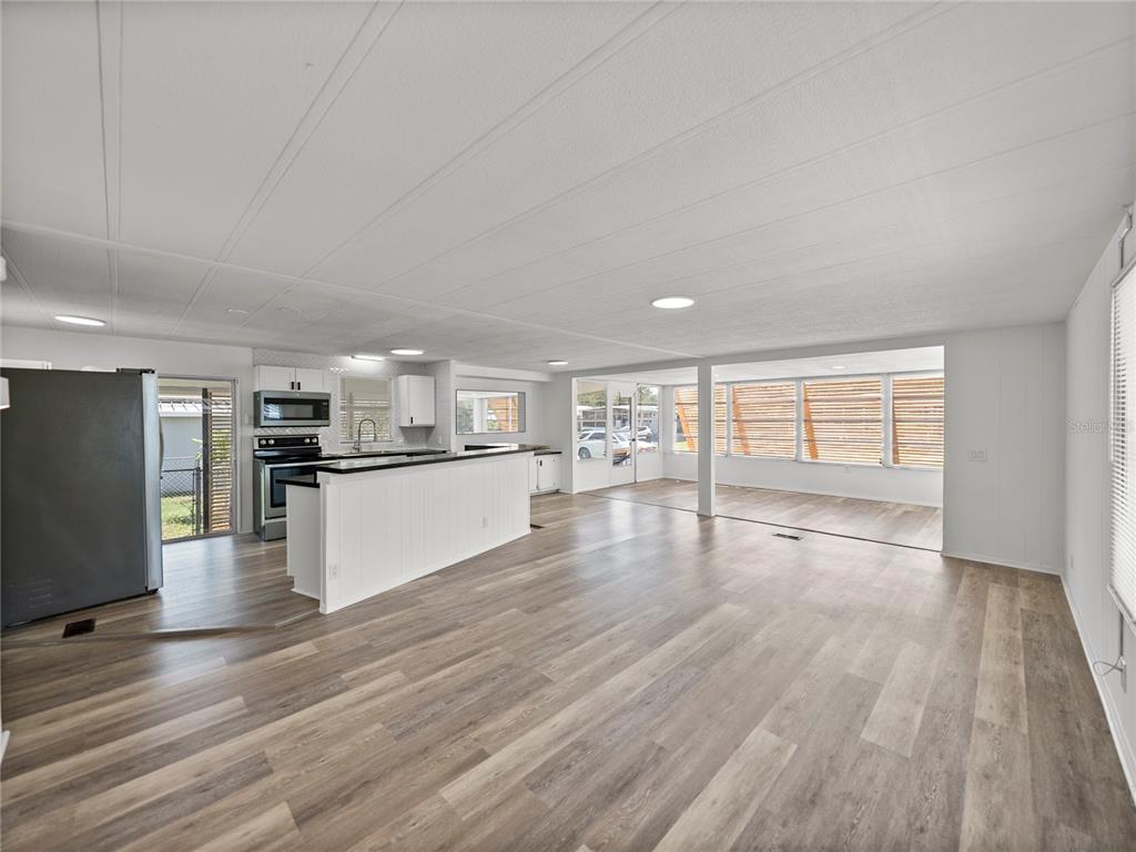 1610 Reynolds Road, Unit 35 Lakeland, FL 33801 - Photo 9 of 59 a view of kitchen living room with wooden floor and electronic appliances