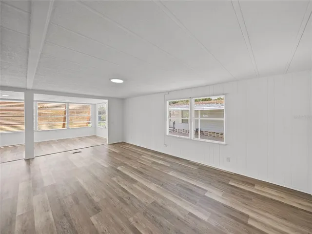 a kitchen with white cabinets and a wooden floor