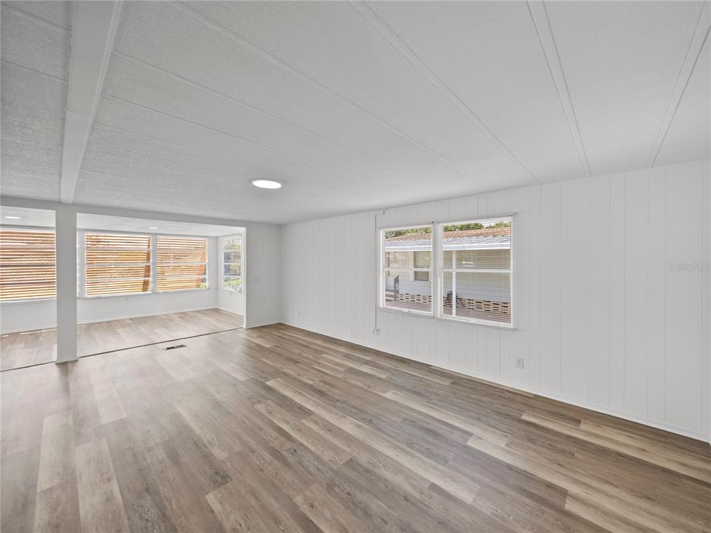 1610 Reynolds Road, Unit 35 Lakeland, FL 33801 - Photo 10 of 59 a view of an empty room with wooden floor and a window