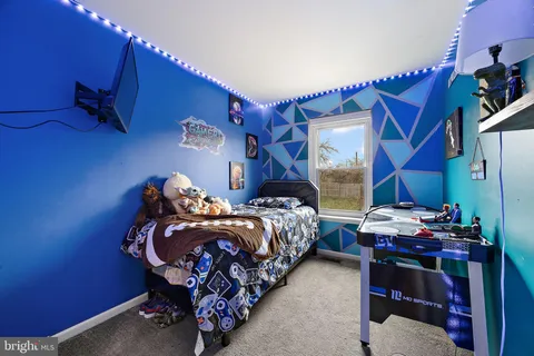 a bed sitting in a room next to a window
