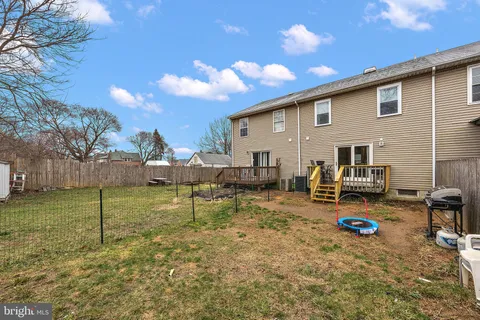 a backyard of a house with barbeque oven table and chairs