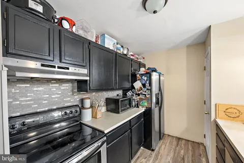 a kitchen with a stove and a refrigerator