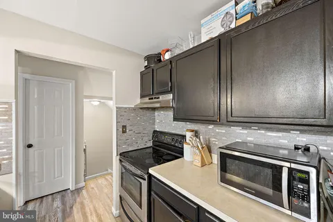 a kitchen with a stove and a microwave