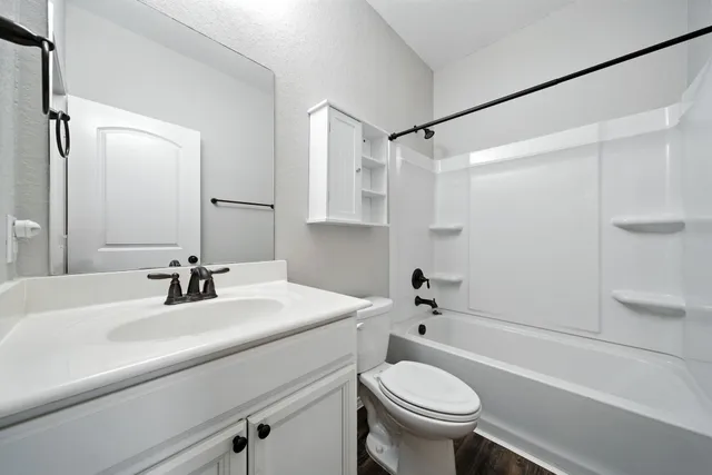 a bathroom with a sink a toilet and a bathtub