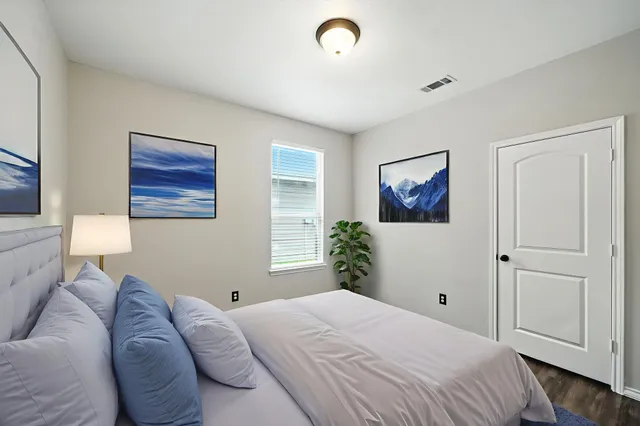 a bedroom with a large bed and a window