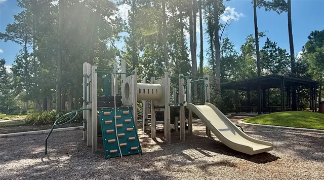 a view of a swimming pool with a patio and fire pit