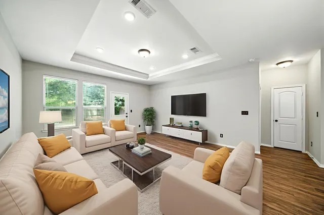 a living room with furniture and a flat screen tv
