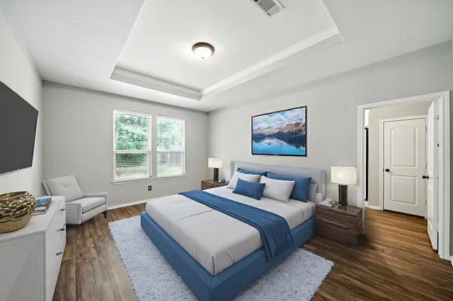 a bedroom with a bed and a flat screen tv