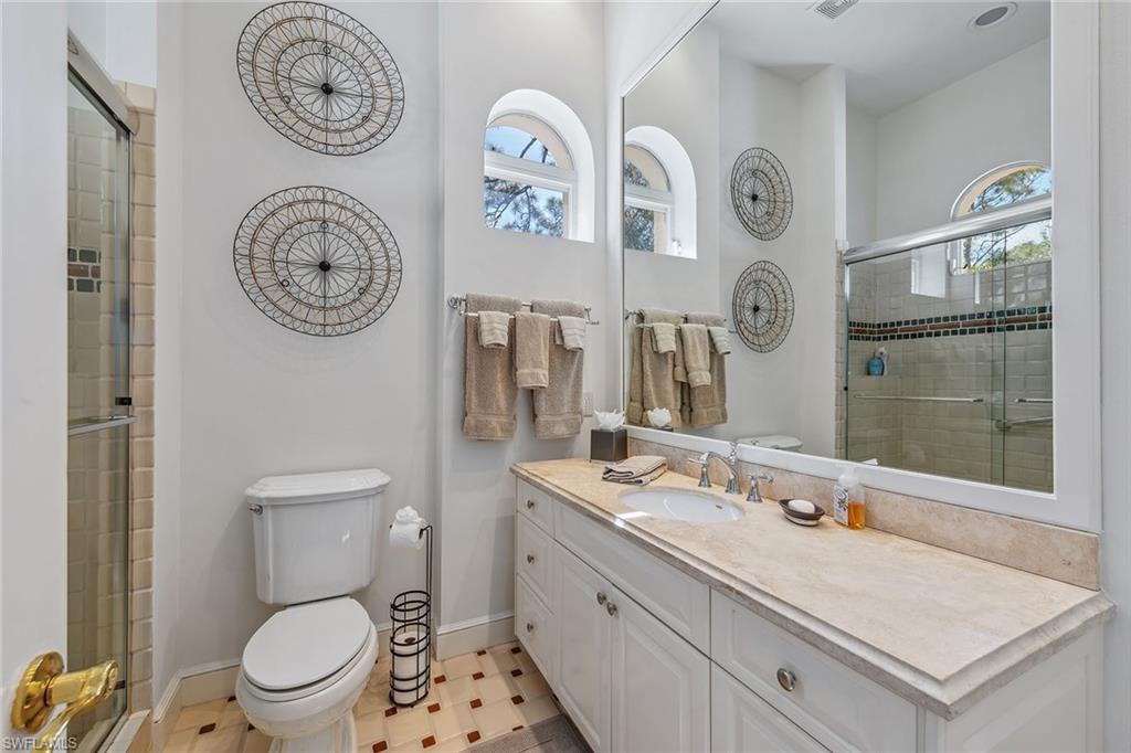 837 Barcarmil Way Naples, FL 34110 - Photo 24 of 38 a bathroom with a toilet and a sink