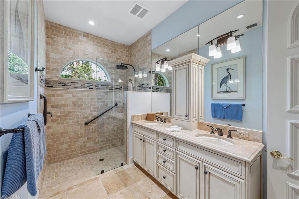 837 Barcarmil Way Naples, FL 34110 - Photo 26 of 38 a bathroom with a double vanity sink mirror and shower