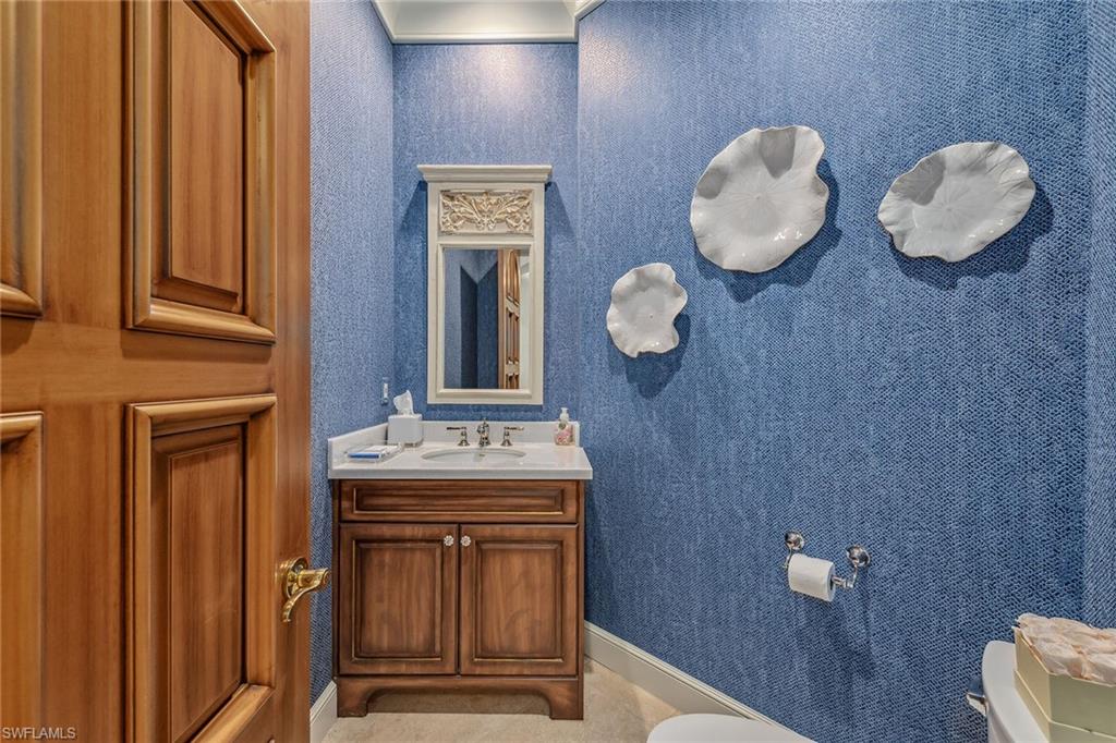 837 Barcarmil Way Naples, FL 34110 - Photo 31 of 38 a view of bathroom with a sink and a mirror