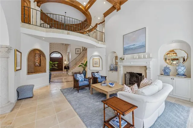 a living room with furniture a rug and a fireplace