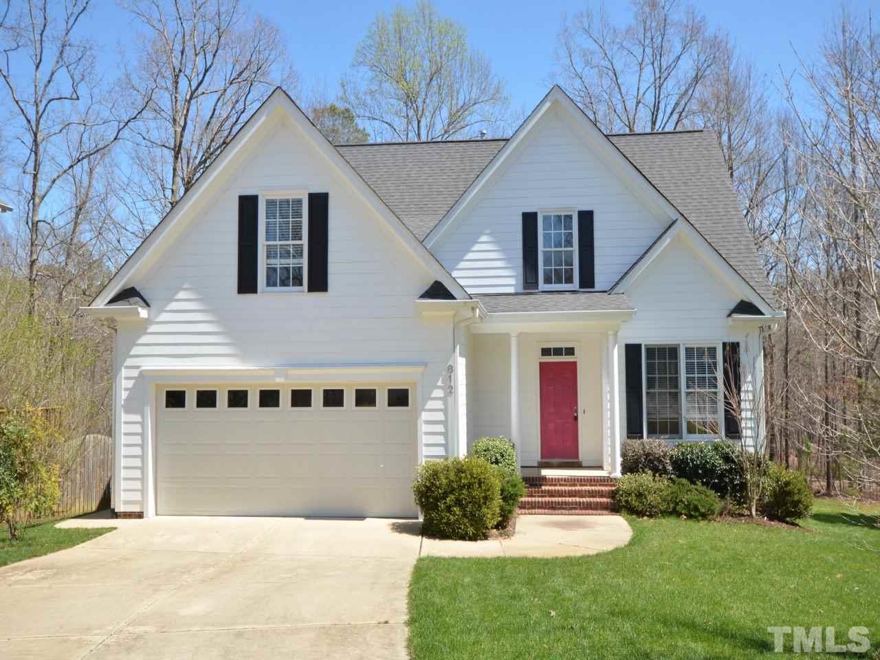 812 Nowell Ridge Road Raleigh, NC 27607 - Photo 2 of 21 a front view of a house with a yard and garage