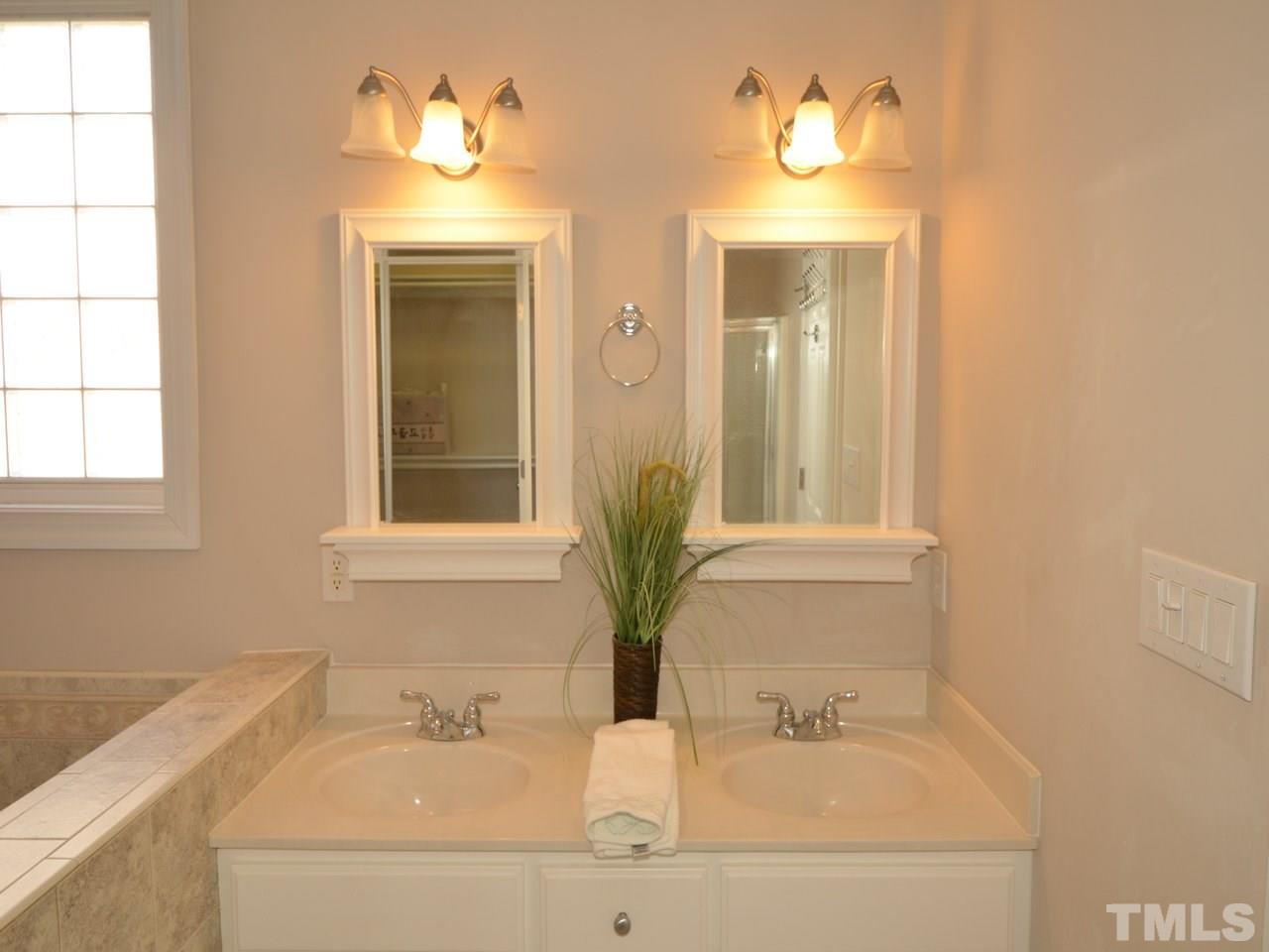 812 Nowell Ridge Road Raleigh, NC 27607 - Photo 11 of 21 a bathroom with a sink and a mirror