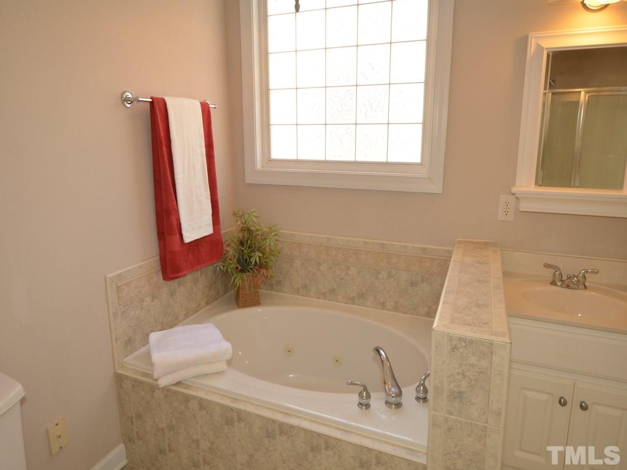812 Nowell Ridge Road Raleigh, NC 27607 - Photo 12 of 21 a bathroom with a tub and a sink