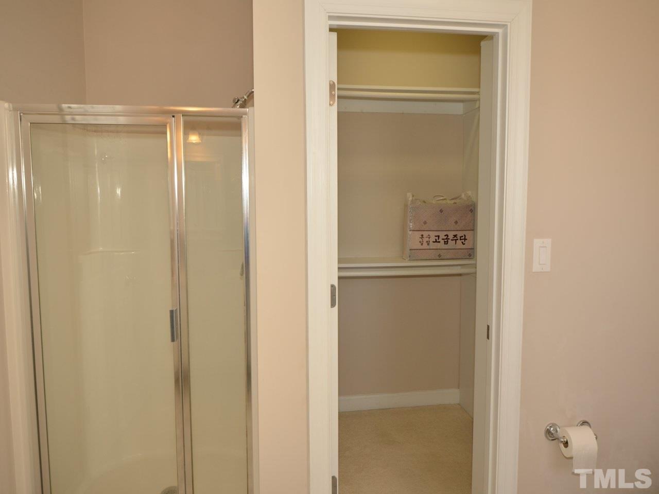 812 Nowell Ridge Road Raleigh, NC 27607 - Photo 13 of 21 a bathroom with a glass shower door