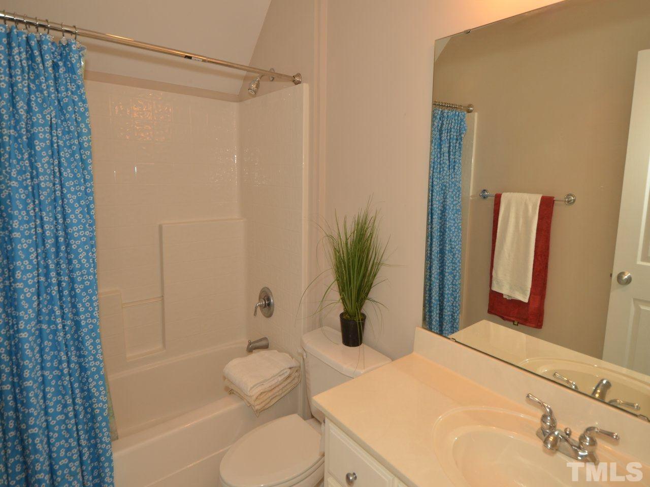 812 Nowell Ridge Road Raleigh, NC 27607 - Photo 14 of 21 a bathroom with a sink a toilet and shower