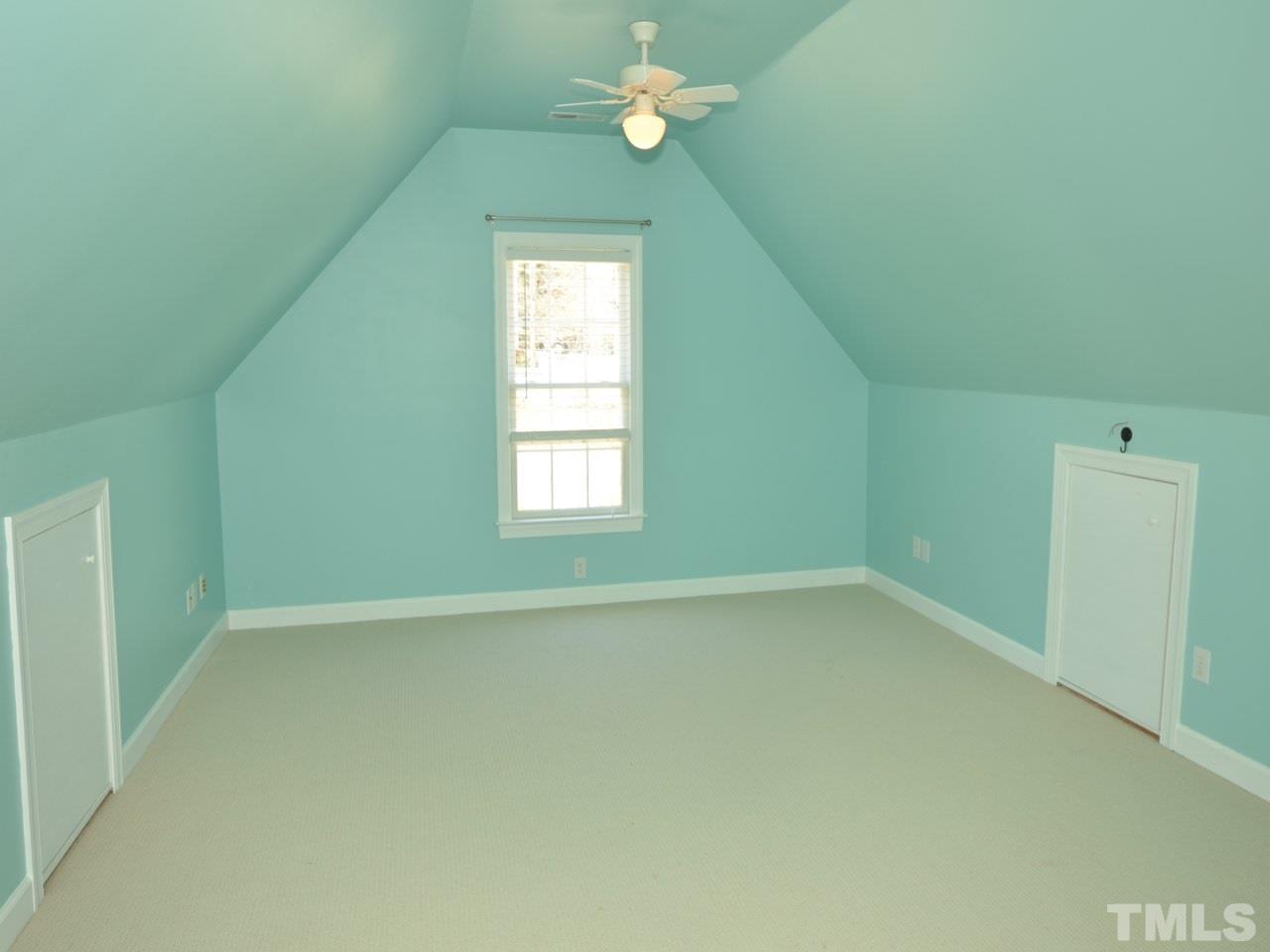 812 Nowell Ridge Road Raleigh, NC 27607 - Photo 15 of 21 an empty room with windows and fan