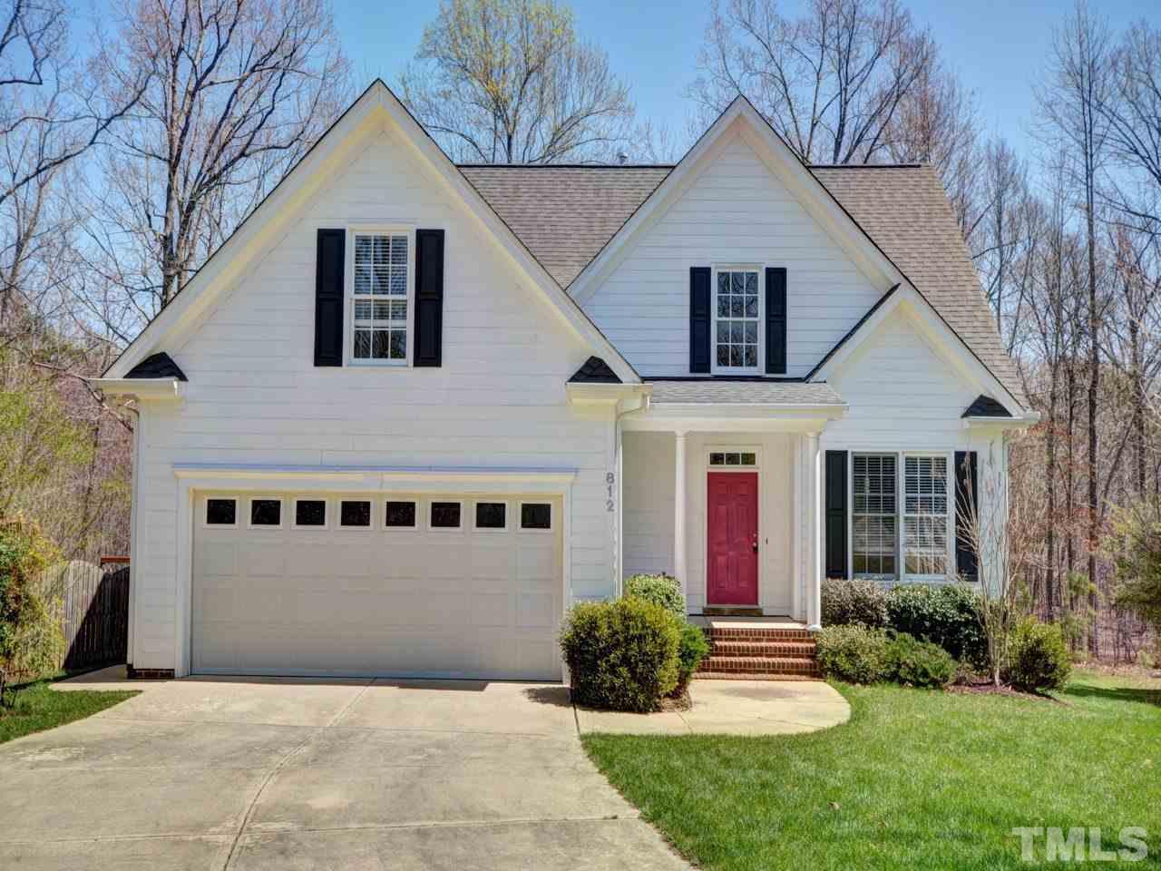 812 Nowell Ridge Road Raleigh, NC 27607 - Photo 20 of 21 a front view of a house with a yard and garage