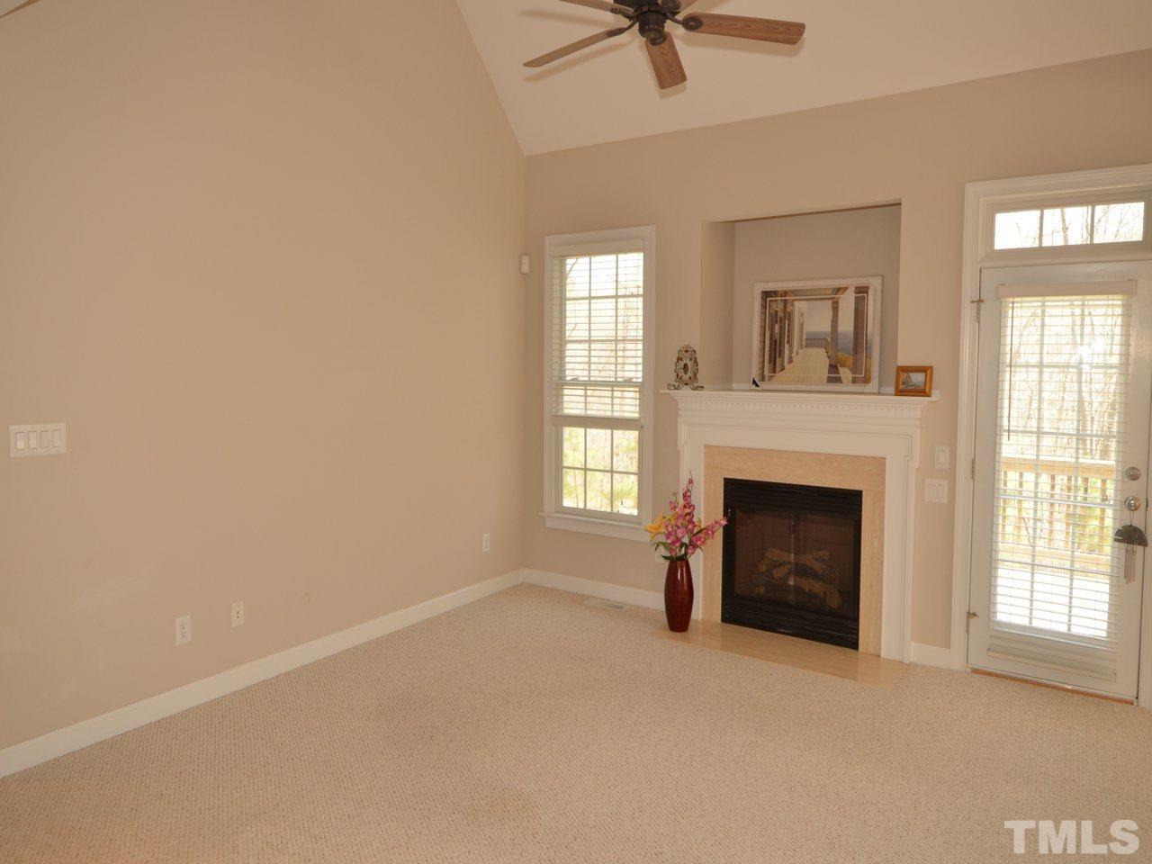 812 Nowell Ridge Road Raleigh, NC 27607 - Photo 5 of 21 a view of empty room with a fireplace and windows
