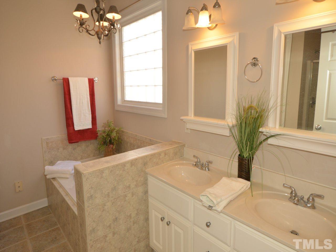 812 Nowell Ridge Road Raleigh, NC 27607 - Photo 10 of 21 a bathroom with a sink and a mirror