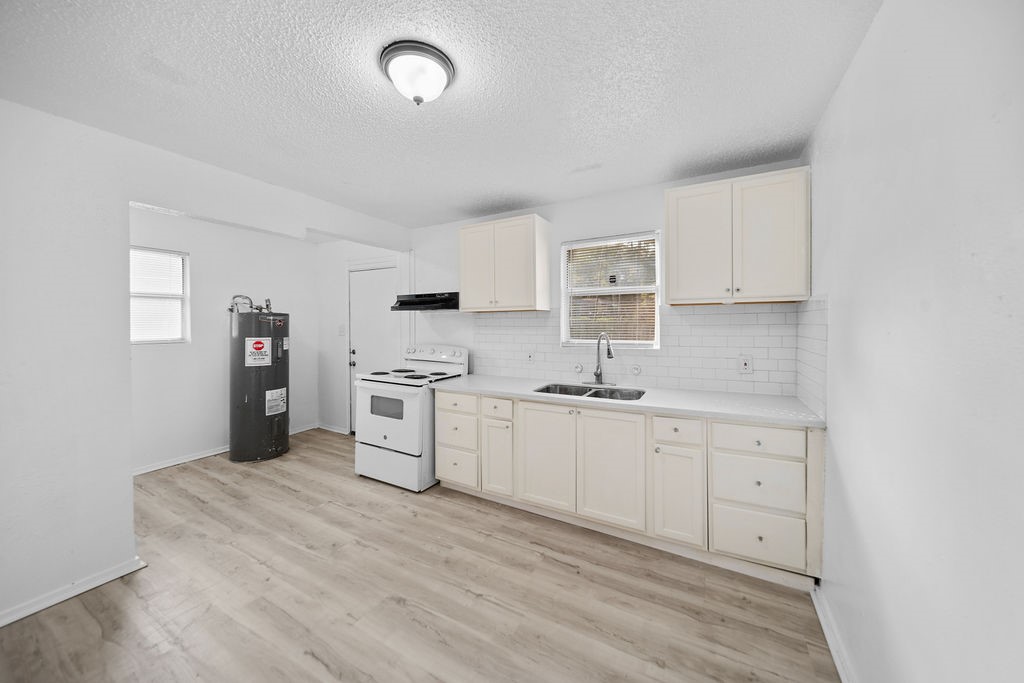 3058 Old Colony Road Huntsville, TX 77320 - Photo 11 of 25 a kitchen with white cabinets and appliances