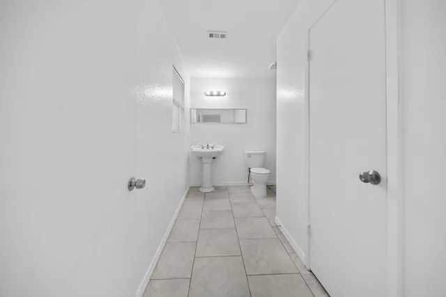 a bathroom with a shower toilet and sink