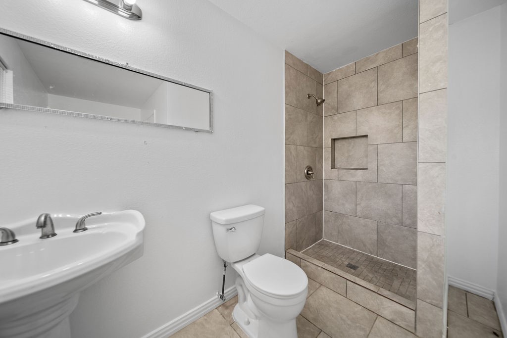 3058 Old Colony Road Huntsville, TX 77320 - Photo 17 of 25 a bathroom with a shower toilet and sink