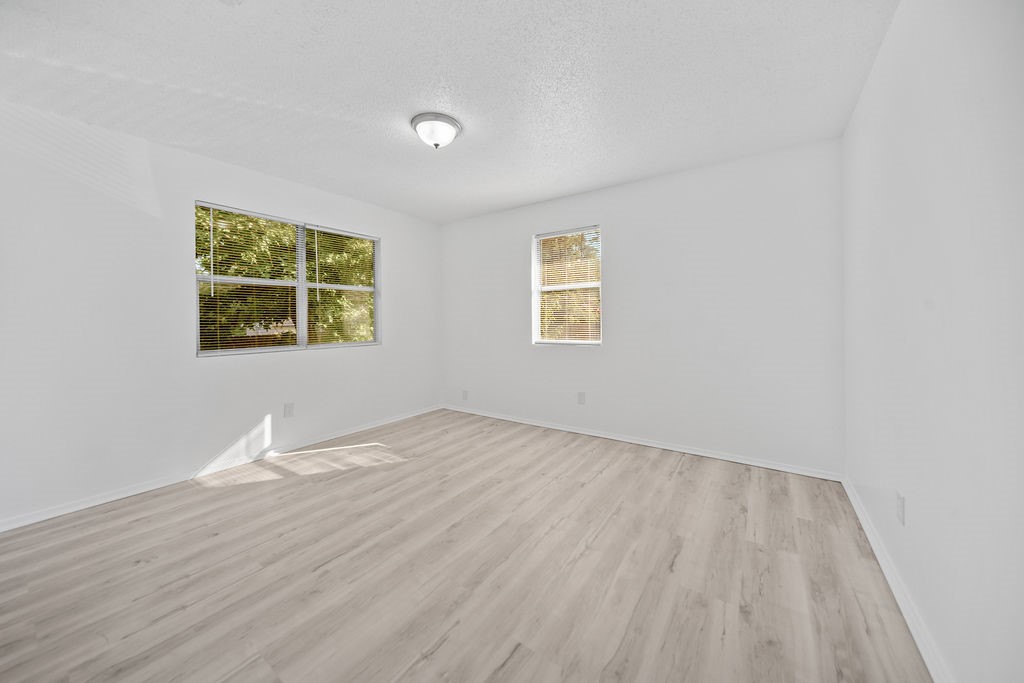 3058 Old Colony Road Huntsville, TX 77320 - Photo 20 of 25 a view of an empty room with a window and wooden floor