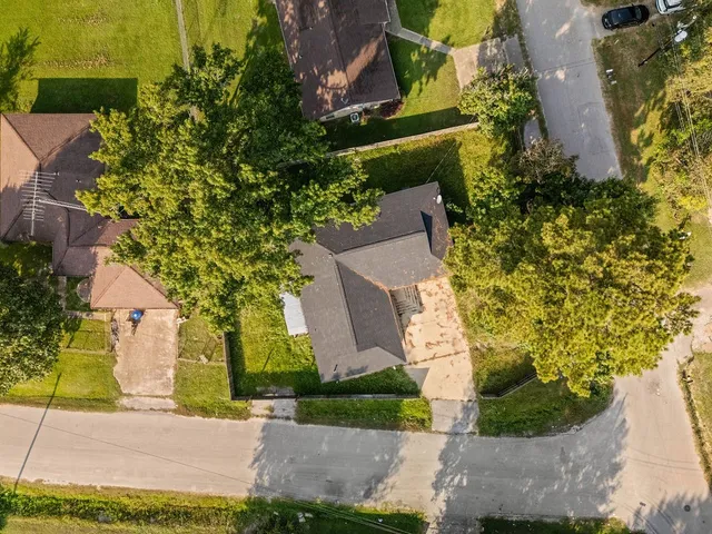 an aerial view of a house with a yard basket ball court and outdoor seating