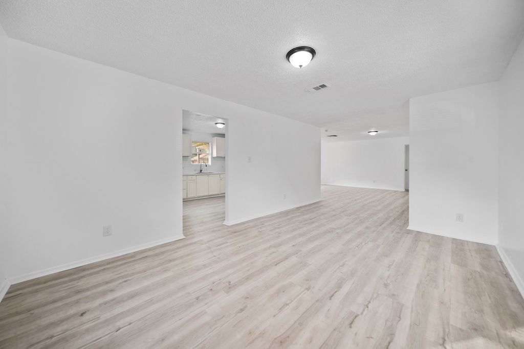 3058 Old Colony Road Huntsville, TX 77320 - Photo 9 of 25 wooden floor in an empty room with a window