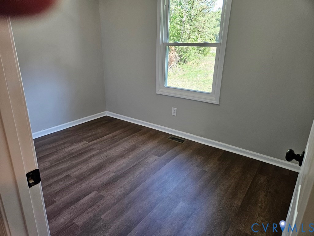 27368 Prince Edward Highway Rice, VA 23966 - Photo 12 of 18 an empty room with wooden floor and windows