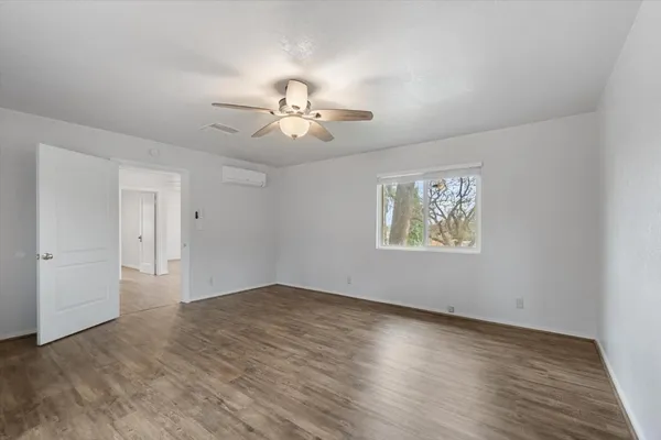 wooden floor in an empty room with a window