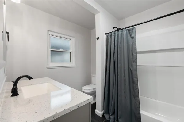 a bathroom with a sink toilet and shower