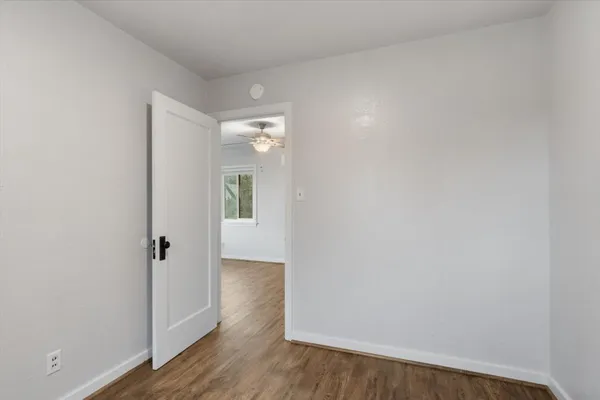 a view of a hallway with wooden floor