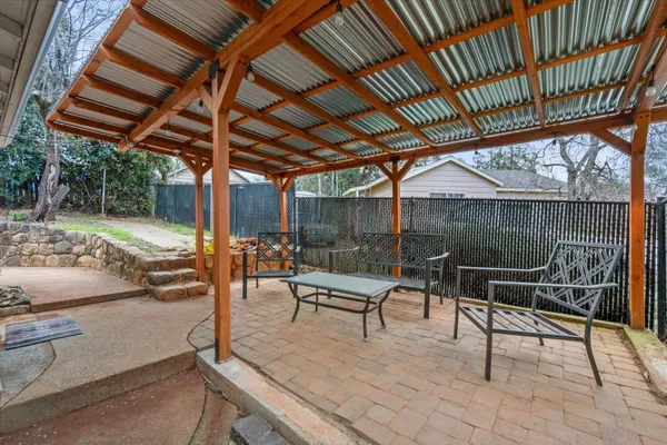 a view of a roof deck with wooden table and chairs
