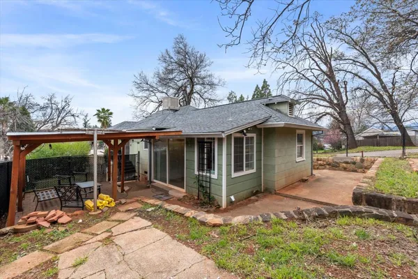 a view of a house with yard and sitting area