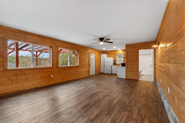a kitchen with a refrigerator and a stove top oven