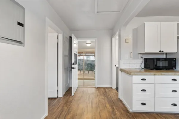 a view of kitchen with wooden floor and electronic appliances