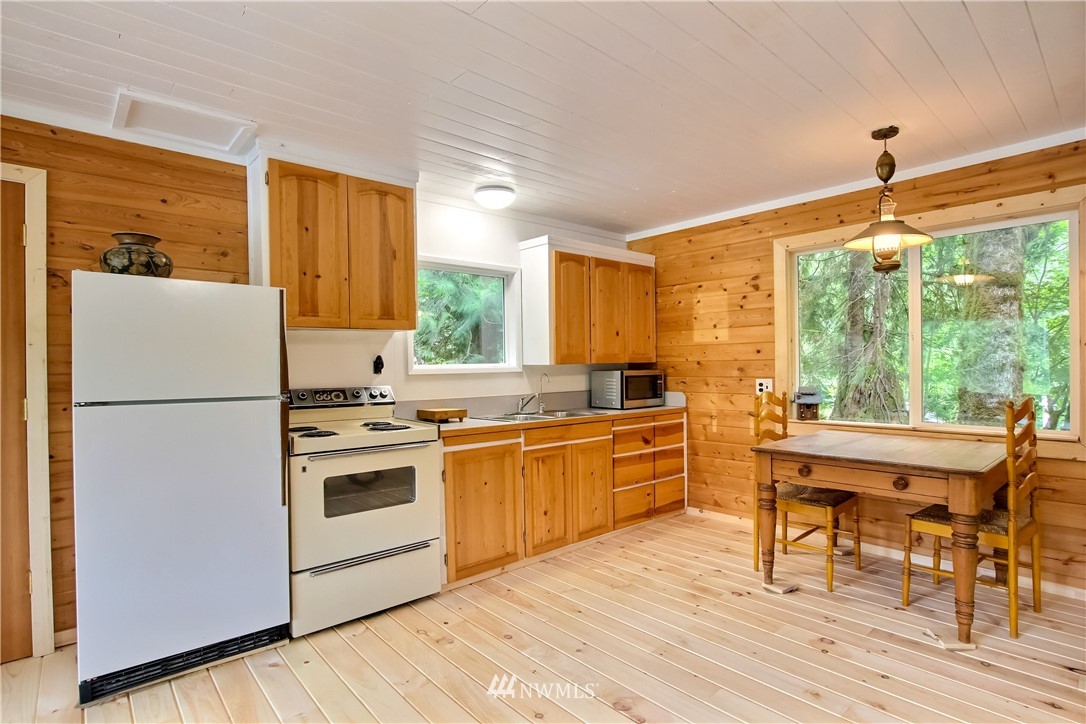 50229 Loop Road Gold Bar, WA 98251 - Photo 13 of 21 a kitchen with a refrigerator a stove top oven and a large window