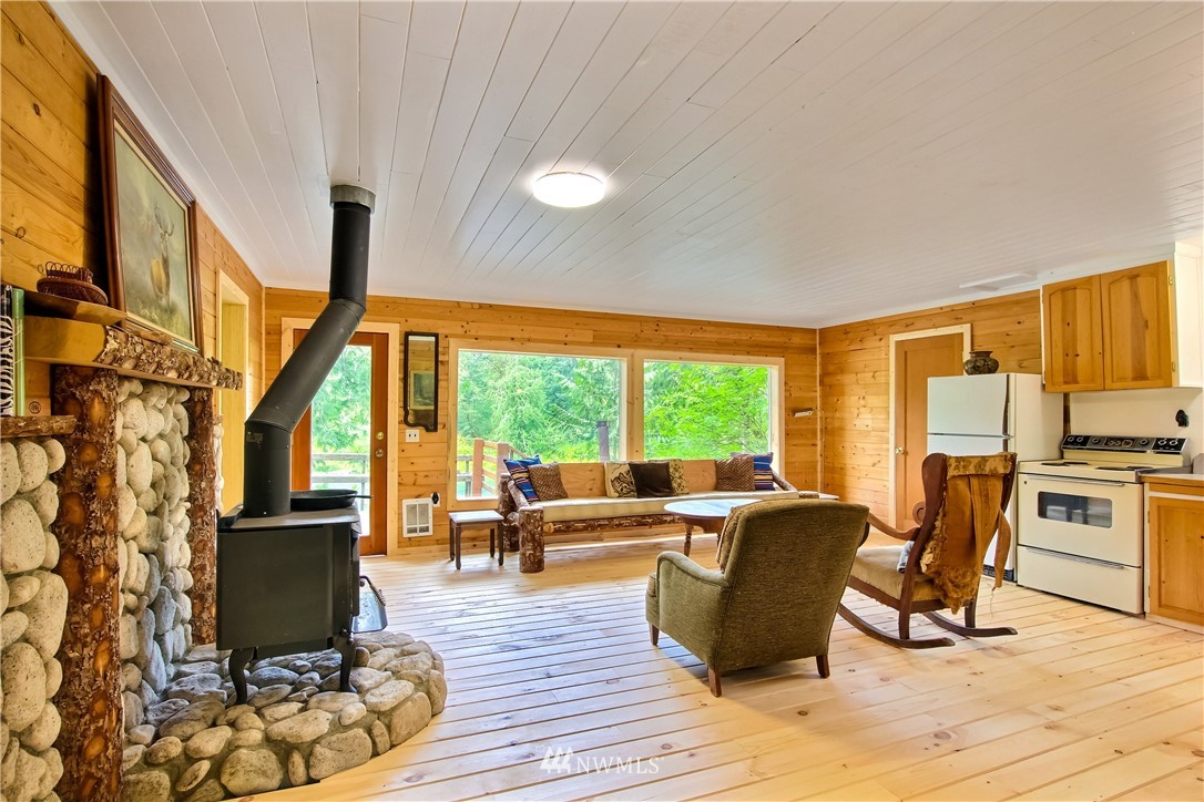 50229 Loop Road Gold Bar, WA 98251 - Photo 7 of 21 a living room with furniture a fireplace and large windows