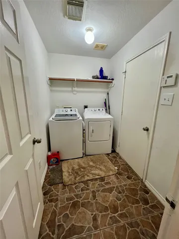 a utility room with a sink dryer and washer