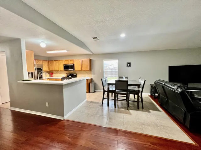 a view of kitchen with cabinets table and chairs