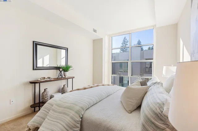 a bedroom with a bed and a table in it