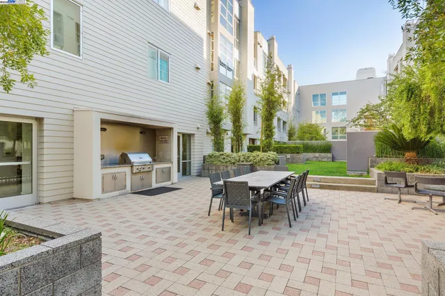 a view of a patio with a table and chairs