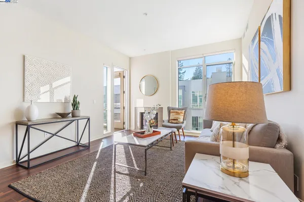 a living room with furniture a rug a lamp and a window